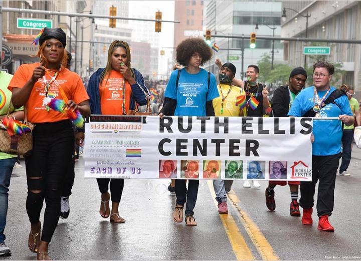 People in the streets holding a Ruth Ellis Center banner