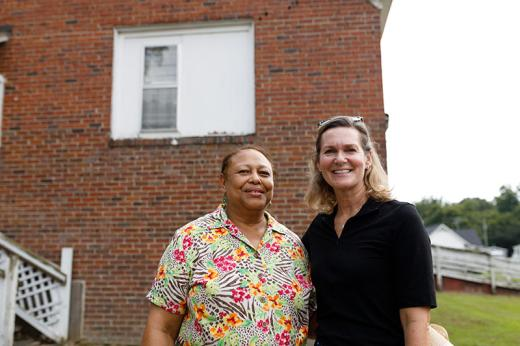 Dr. Clarice White, project champion and Stanton School alumna, and Mary Culler, President of Ford Philanthropy, in front of the Ford Community Center.