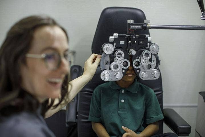 Woman testing the eyes of a kid