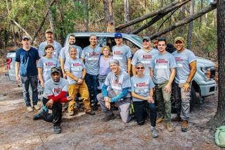 Rubicon team members posing in front of a Ford Truck