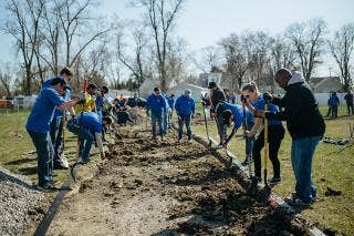 A dozen plus volunteers building a walkway.