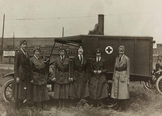Six Red Cross workers with a Ford Military Ambulance outside the Highland Park Plant, 1918.