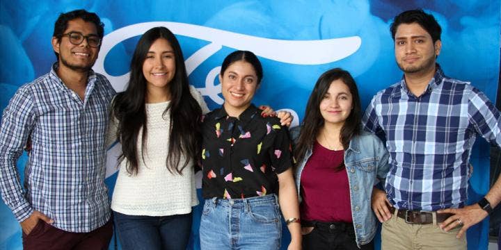 Five people posing for a photo