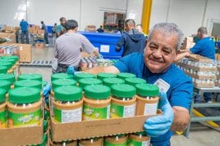 A man stocking peanut butter