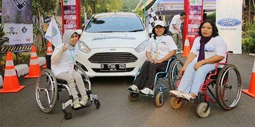 people in front of a car