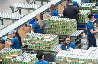 People stocking stacks of food