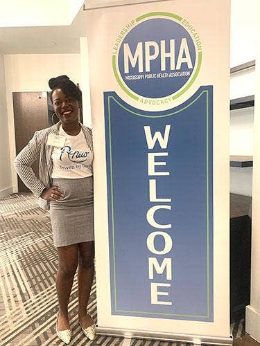Woman next to a MPHA sign