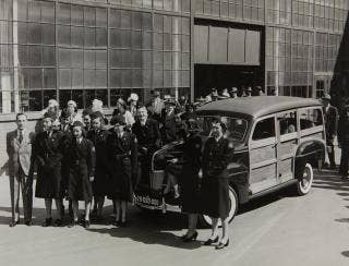 Edsel Ford presents the 29-millionth Ford to the Red Cross, April 29, 1941. This first Ford vehicle donation to the American Red Cross during WWII was a Super Deluxe Station Wagon with a Motor Corps insignia and a special 29,000,000 license plate.