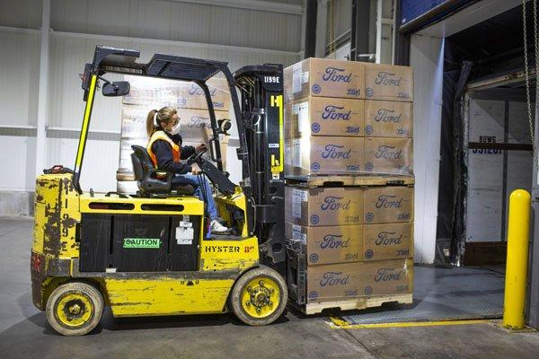 a woman driving a lift