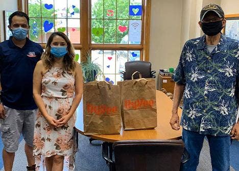 People posing with bags