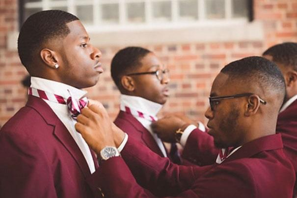 a man fixing the tie of another