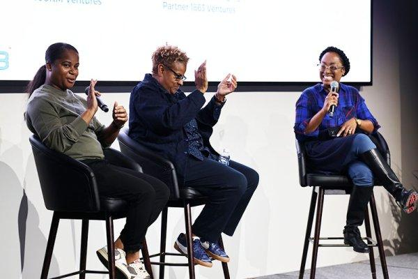 Bradley Melissa with two women giving a speech