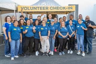 Volunteer check-in stand with various volunteers