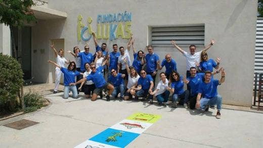 A group of volunteers standing at the front door of the Lukas Foundation