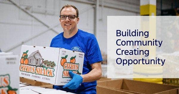 A man carrying a box of food and text on the right