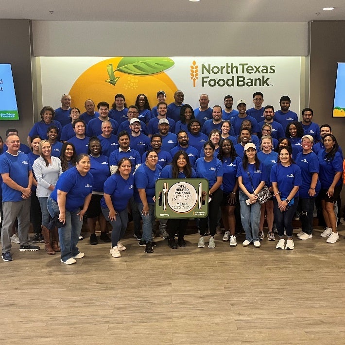 A group of people in blue shirts AI-generated content may be incorrect.