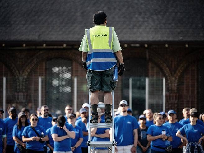 A person standing next to another group of people