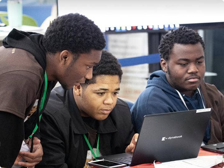 A group of boys working with a computer