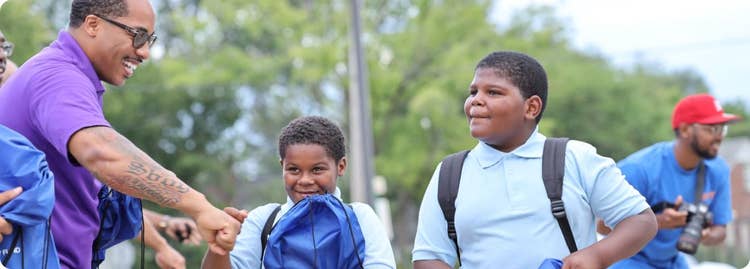 person handing things to kids