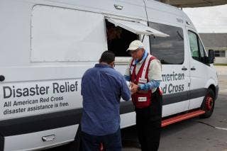 American Red Cross Volunteer assisting someone