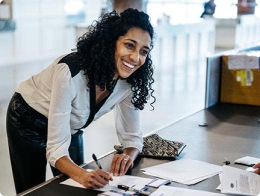 A woman signing a paper