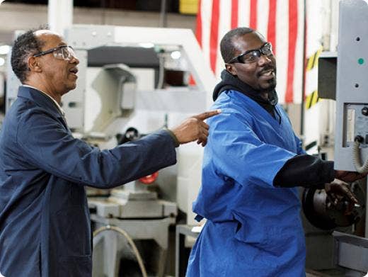 A student and a teacher at a technical training