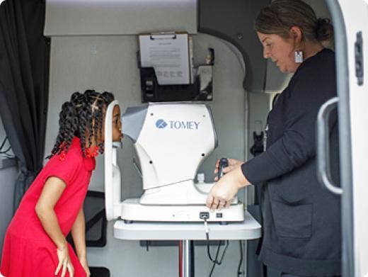 A girl getting her eyes checked at a mobile center